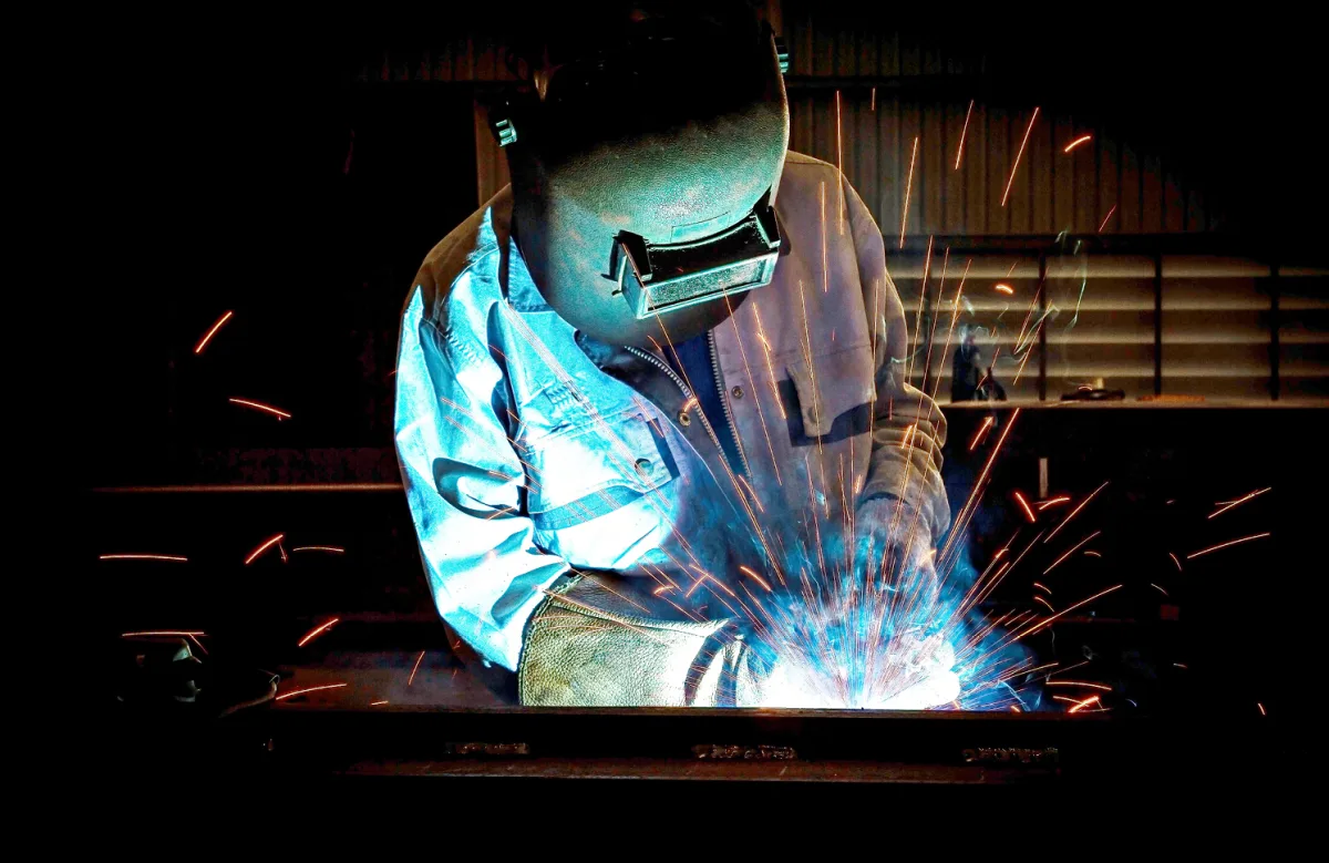 Welder working during construction of the first CRTs